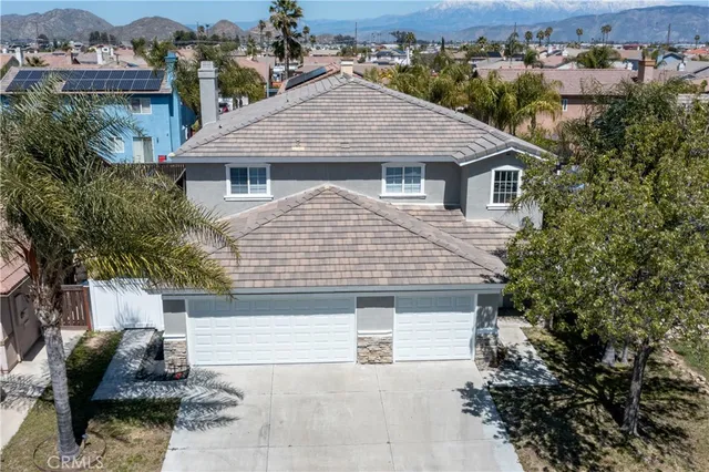 a aerial view of a house with a yard and potted plants