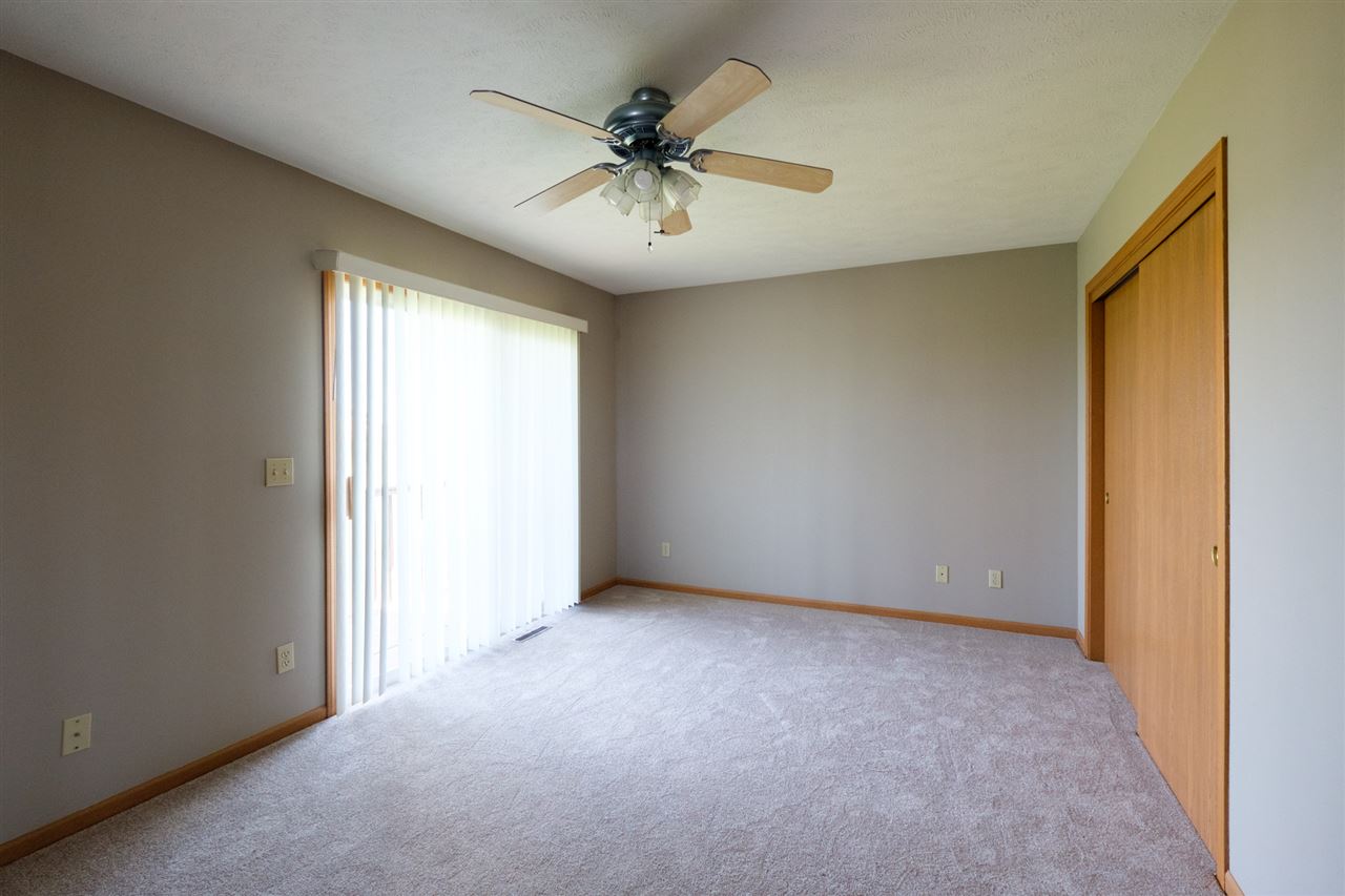 5378 Torque Road Loves Park, IL 61111 - Photo 13 of 24 an empty room with windows and ceiling fan