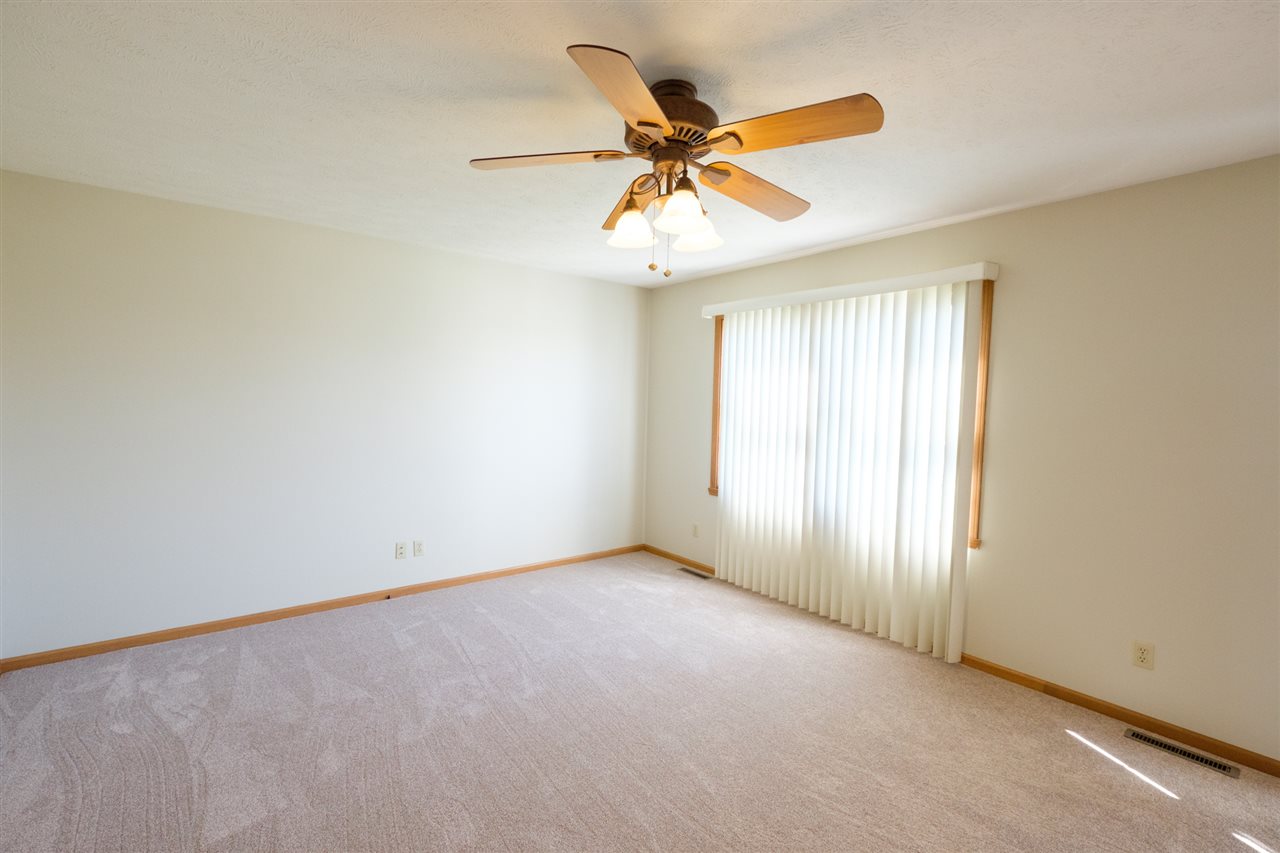 5378 Torque Road Loves Park, IL 61111 - Photo 3 of 24 an empty room with windows and fan