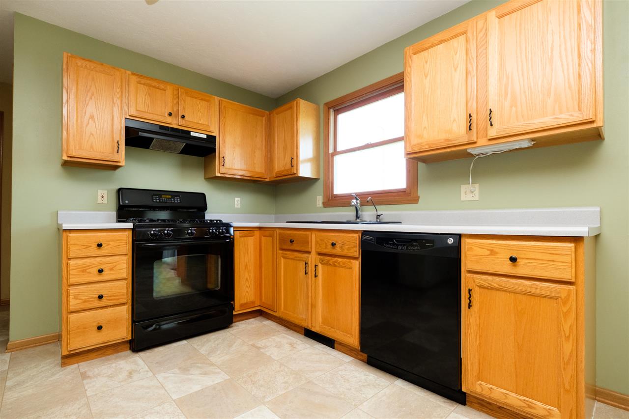 5378 Torque Road Loves Park, IL 61111 - Photo 6 of 24 a kitchen with granite countertop a sink cabinets stainless steel appliances and a window