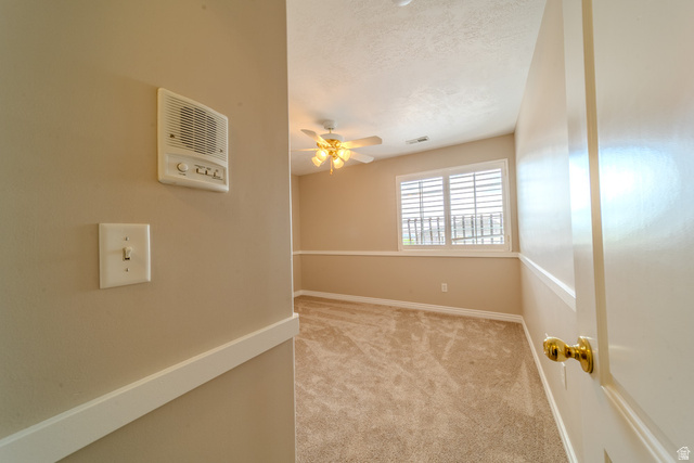 598 Hollow Creek Road Draper, UT 84020 - Photo 83 of 110 Carpeted room featuring a ceiling fan with light fixture, window with white louvered shutters, and a chair rail molding