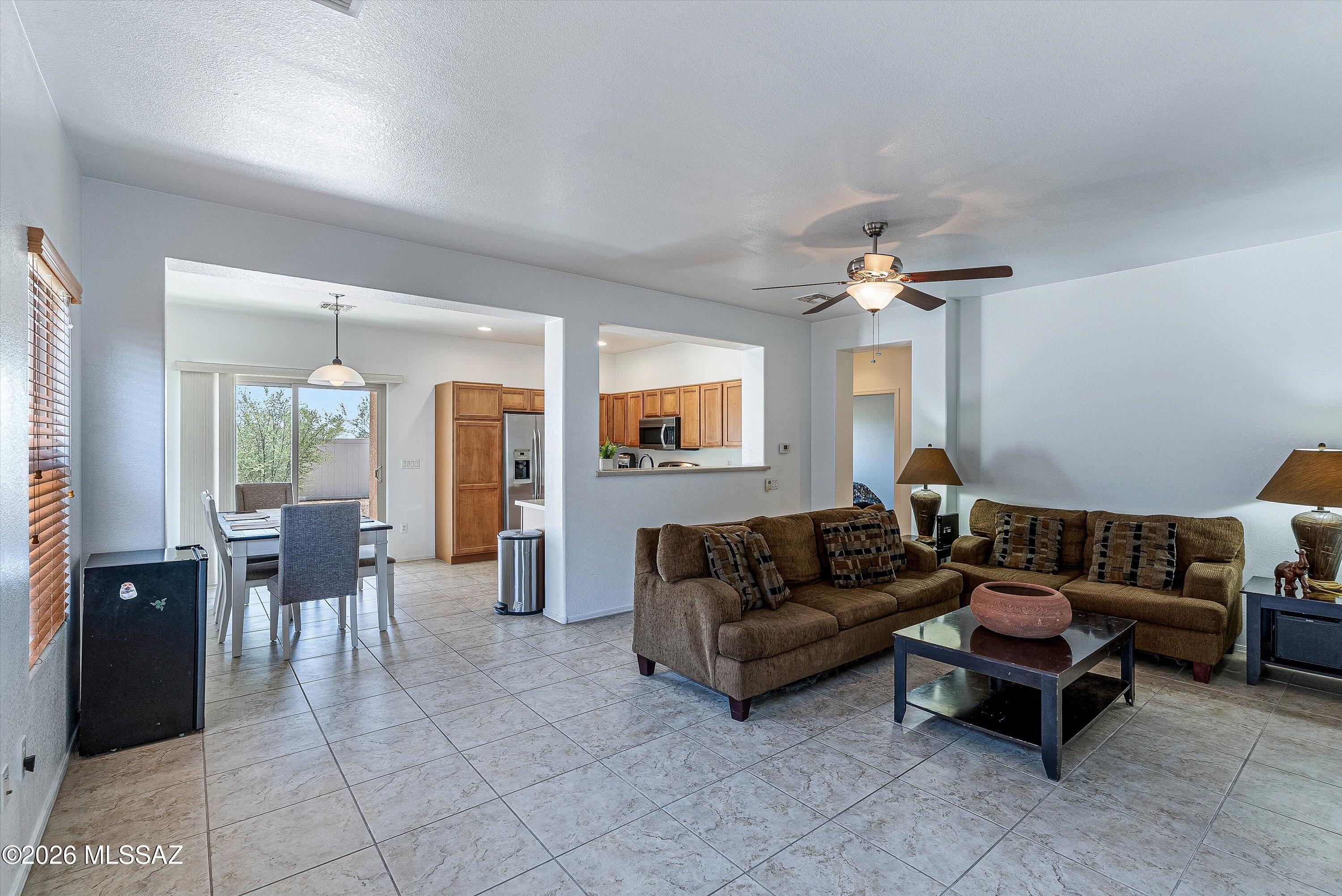 21163 East Treasure Road Red Rock, AZ 85145 - Photo 5 of 35 a living room with furniture and a chandelier
