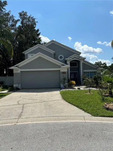 a front view of a house with a yard and a garage