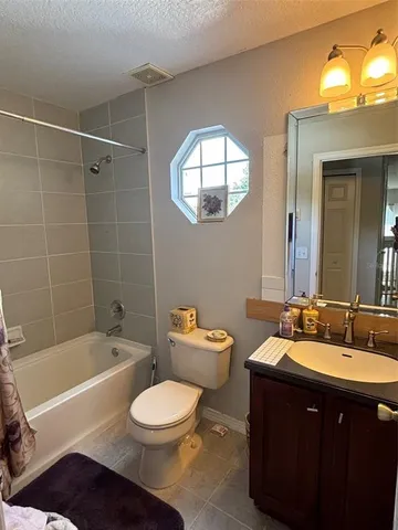 a bathroom with a sink a toilet a mirror and bathtub