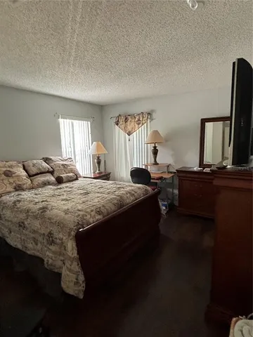 a bed sitting in a bedroom next to a window with tv