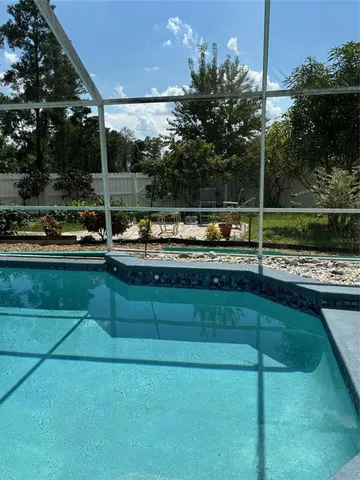 a view of a swimming pool with a yard