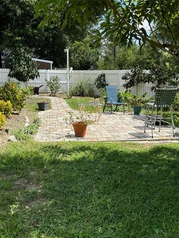 a view of backyard of house with seating space