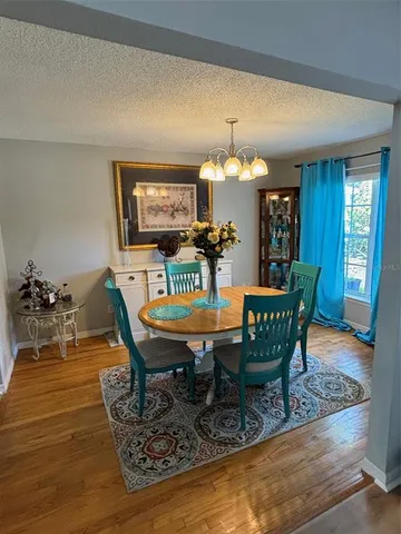 a view of a dining room with furniture and chandelier