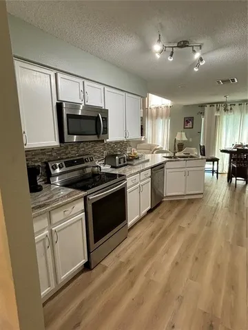 a kitchen with a stove a sink and a microwave
