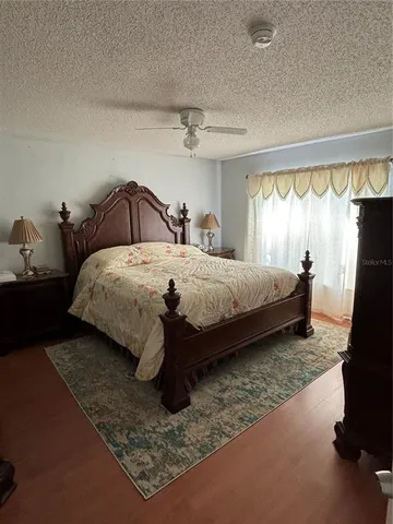 a bedroom with bed and a window