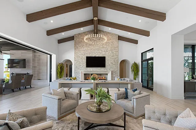 a living room with furniture a fireplace and a flat screen tv