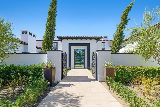 a living room with furniture or chandelier and a large window
