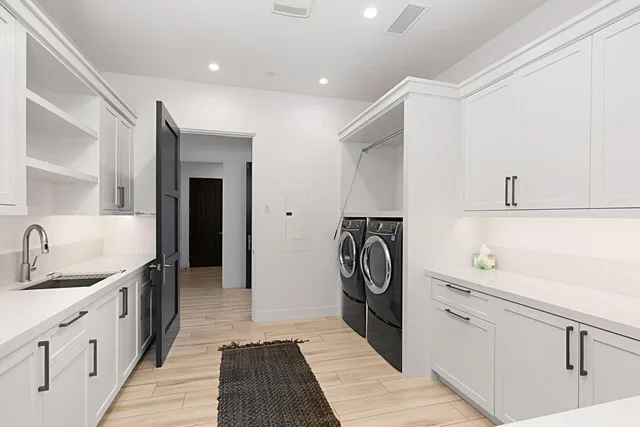 a bedroom with a large bed and a chandelier