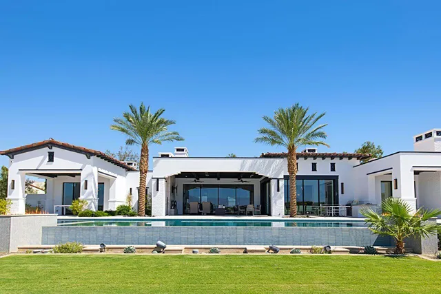 a view of swimming pool with outdoor seating and city view