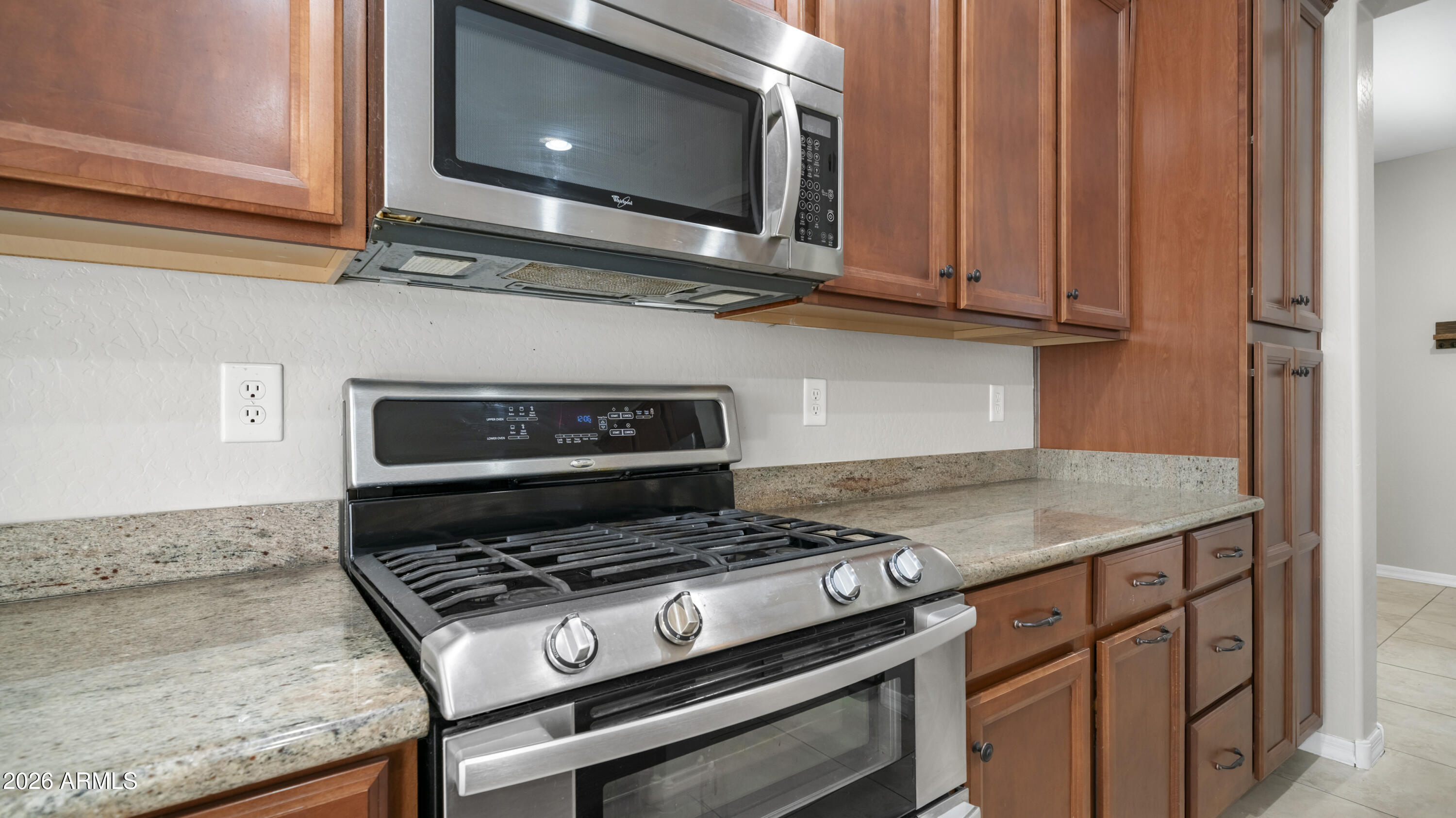 16159 West Granada Road Goodyear, AZ 85395 - Photo 16 of 41 a stove top oven sitting inside of a kitchen