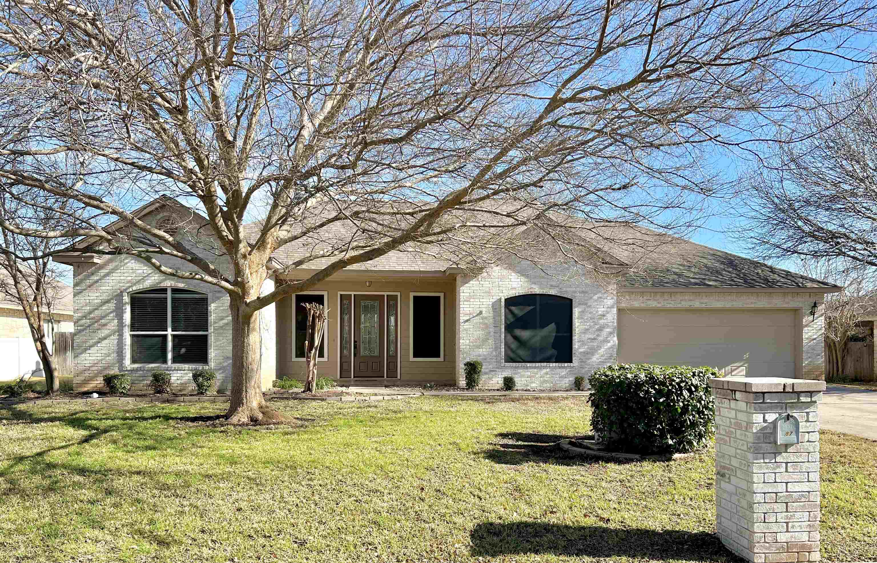 a front view of a house with a yard