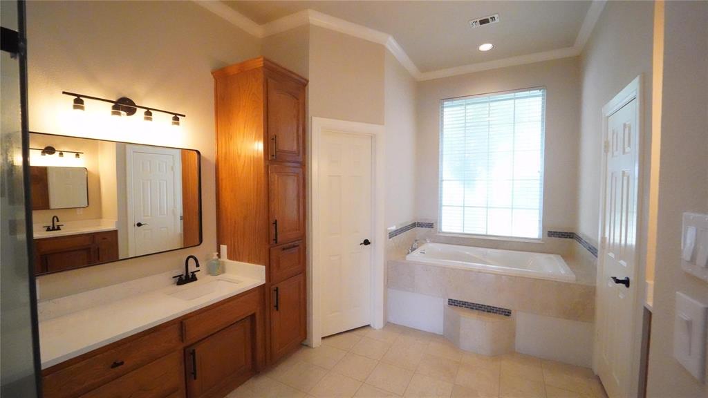 3718 Cliff View Loop Weatherford, TX 76087 - Photo 11 of 24 a bathroom with a tub sink and mirror