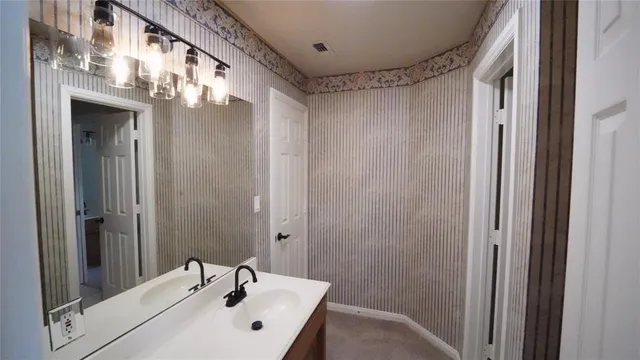 a bathroom with a sink a mirror and a shower