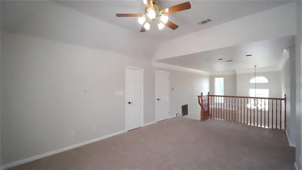 a view of a livingroom and a chandelier fan