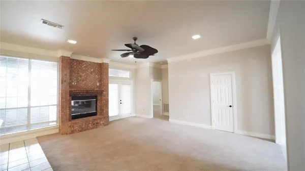 a view of a livingroom with a fireplace and window