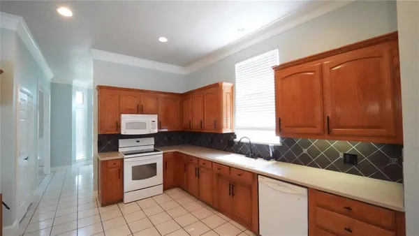 a kitchen with a sink cabinets and window