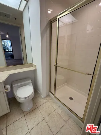 a spacious bathroom with a granite countertop toilet and a sink