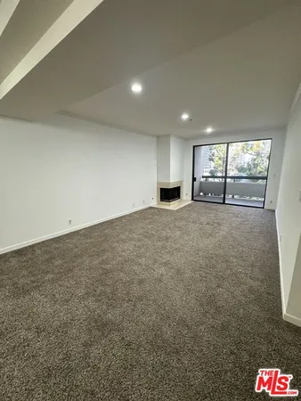 a view of an empty room with white walls