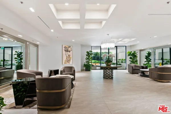 a view of a patio with table and chairs under an umbrella with a patio