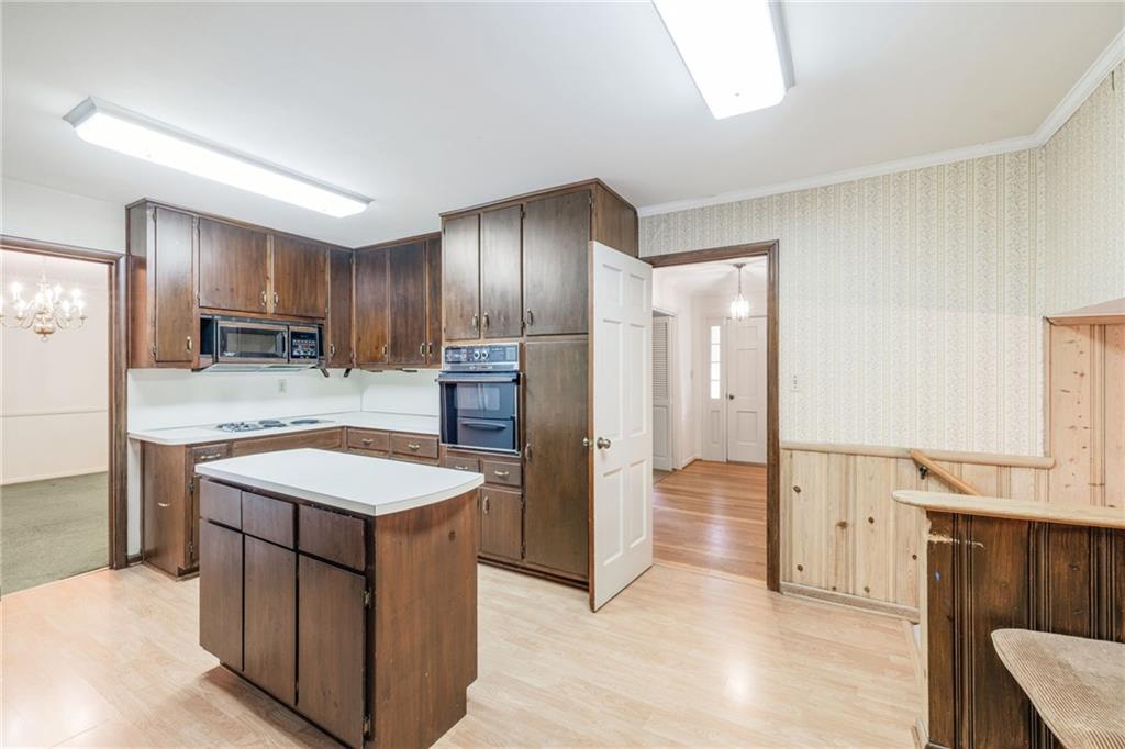 1911 Alderbrook Road Northeast Atlanta, GA 30345 - Photo 13 of 33 a kitchen with stainless steel appliances granite countertop cabinets and wooden floor