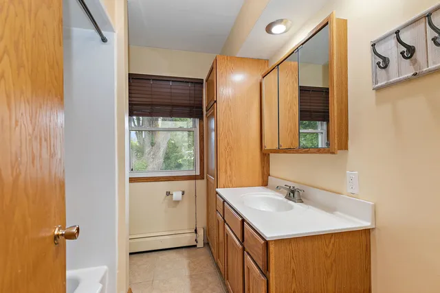 a bathroom with a sink a mirror and a shower