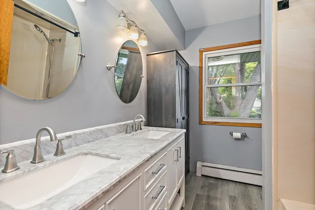 a bathroom with a granite countertop sink and a mirror
