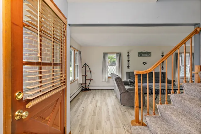 a view of entryway with wooden floor and windows