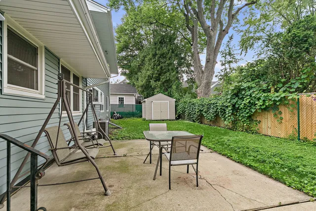 a view of a chairs and table in backyard of the house
