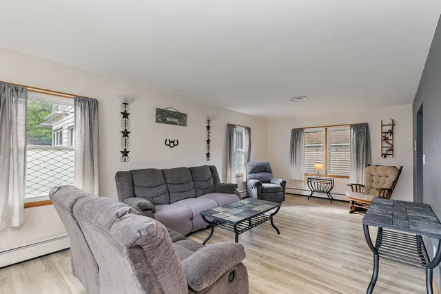 a living room with furniture and wooden floor