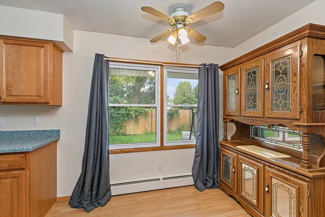 a kitchen with stainless steel appliances granite countertop a stove a refrigerator and a sink with wooden cabinets