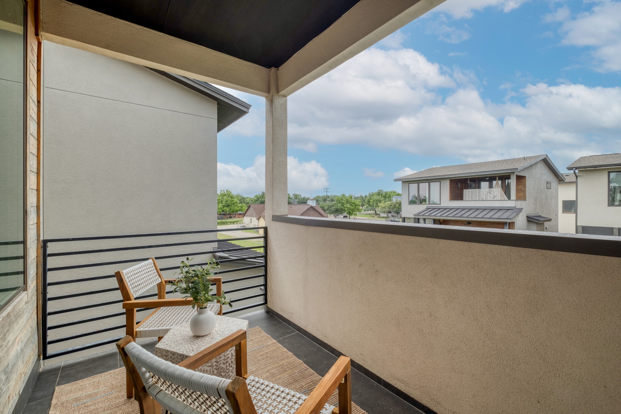 5002 Pecan Springs Road, Unit 7 Austin, TX 78723 - Photo 24 of 34 This upper-level balcony is shared between the primary and the third-floor guest room, offering a private perch for morning coffee