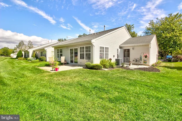 a front view of house with yard and outdoor seating