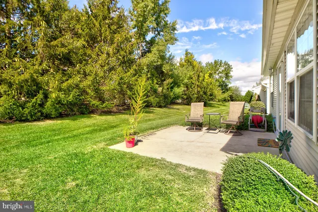 a backyard of a house with table and chairs