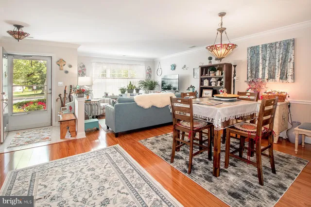 a living room with dining room and wooden floor