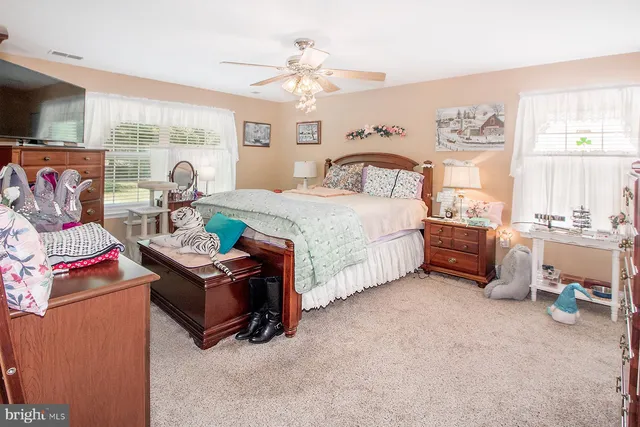 a bedroom with a bed furniture and a large window