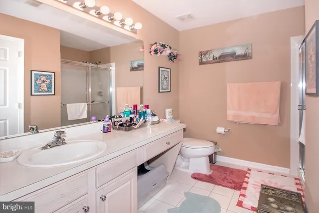 a bathroom with a sink mirror and toilet