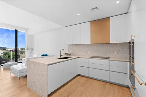 a kitchen with a sink cabinets and wooden floor