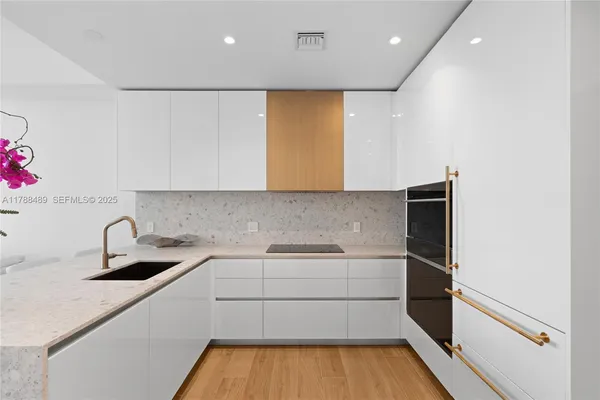 a kitchen with a sink and refrigerator