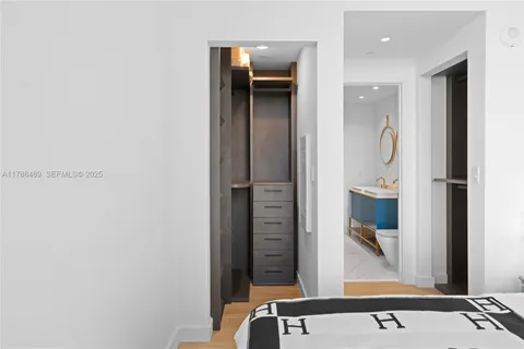 a bed sitting in a bedroom next to a window