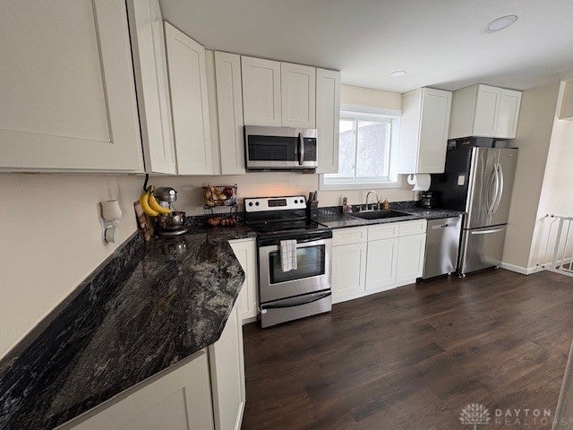 1513 Ridgeway Drive Springfield, OH 45506 - Photo 13 of 53 This modern kitchen features dark countertops and sleek appliances, perfect for culinary adventures.