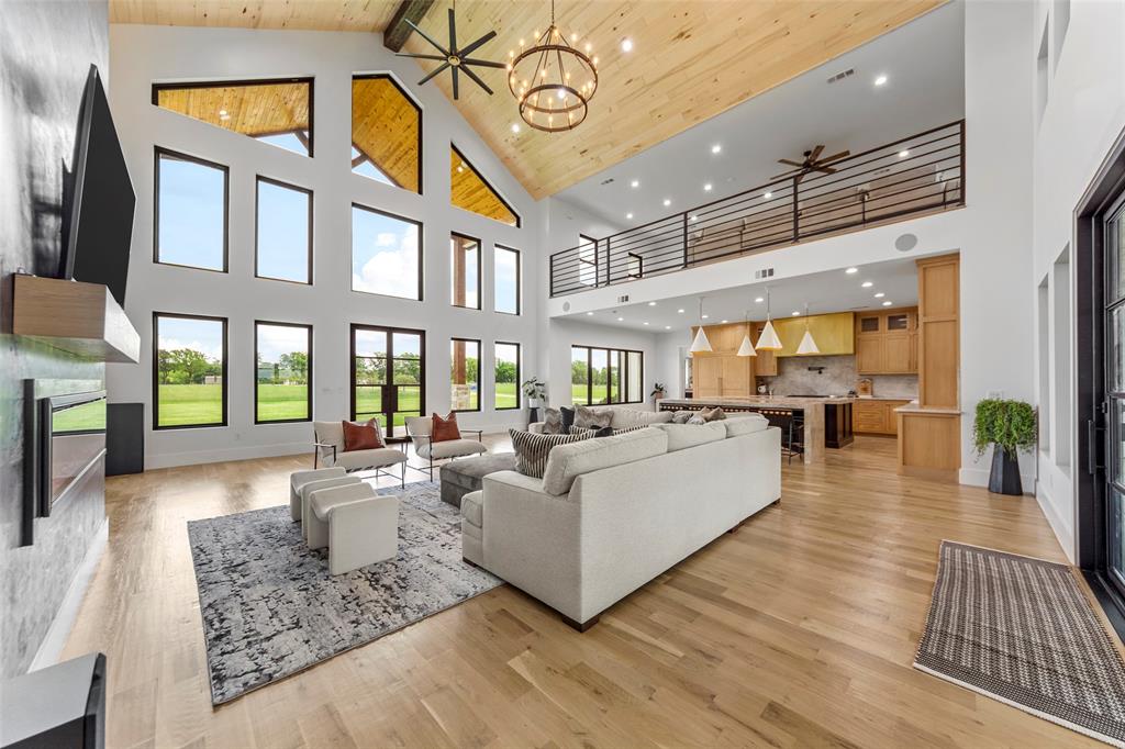 a living room with furniture and a floor to ceiling window