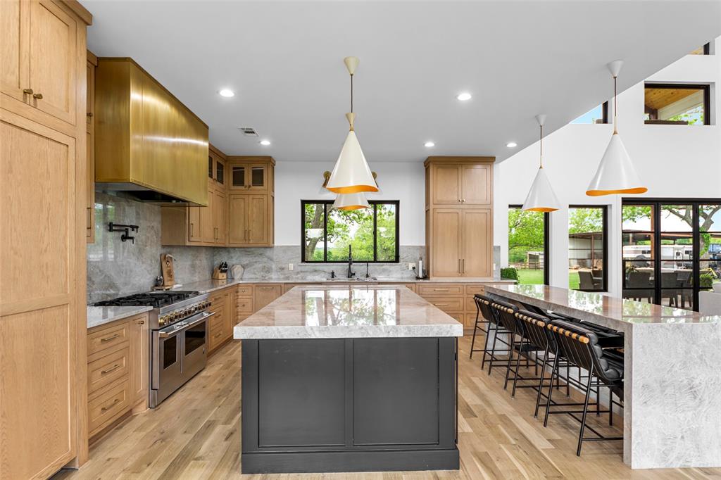 1088 Smith Oak Road Sherman, TX 75090 - Photo 11 of 39 a kitchen with stainless steel appliances granite countertop a stove a sink and a microwave