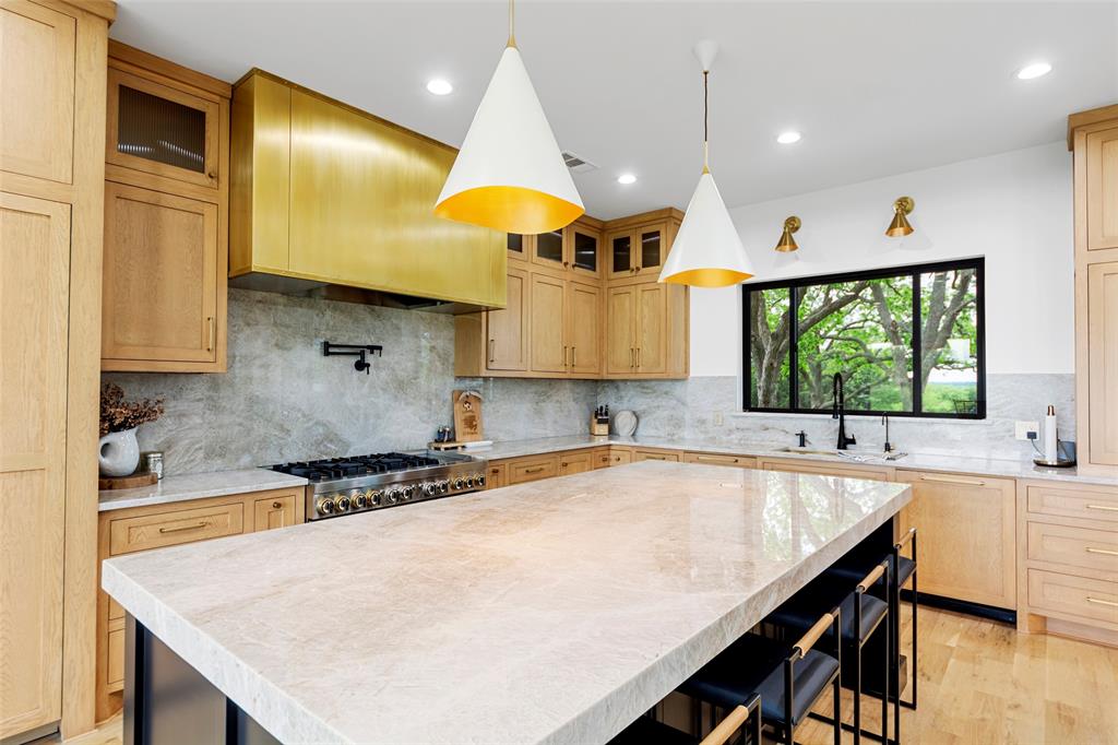 1088 Smith Oak Road Sherman, TX 75090 - Photo 12 of 39 a kitchen with a table a sink and cabinets
