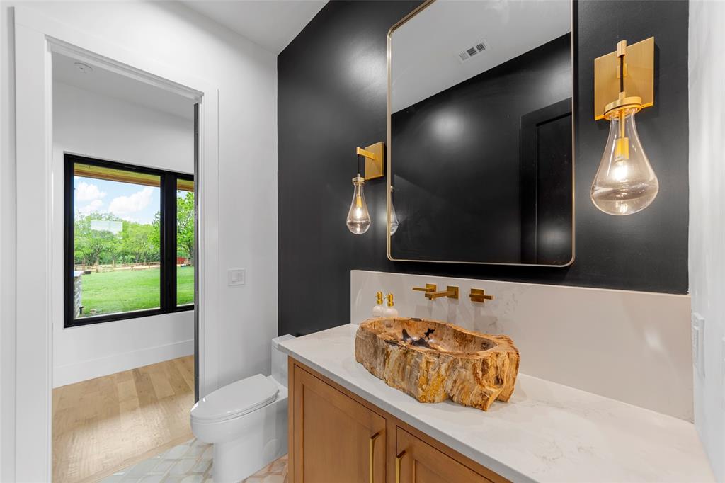 1088 Smith Oak Road Sherman, TX 75090 - Photo 13 of 39 a bathroom with a sink and a mirror