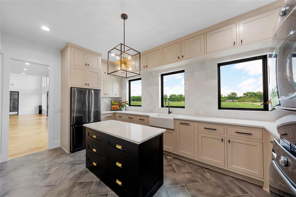 1088 Smith Oak Road Sherman, TX 75090 - Photo 18 of 39 a large kitchen with stainless steel appliances granite countertop a sink refrigerator and cabinets